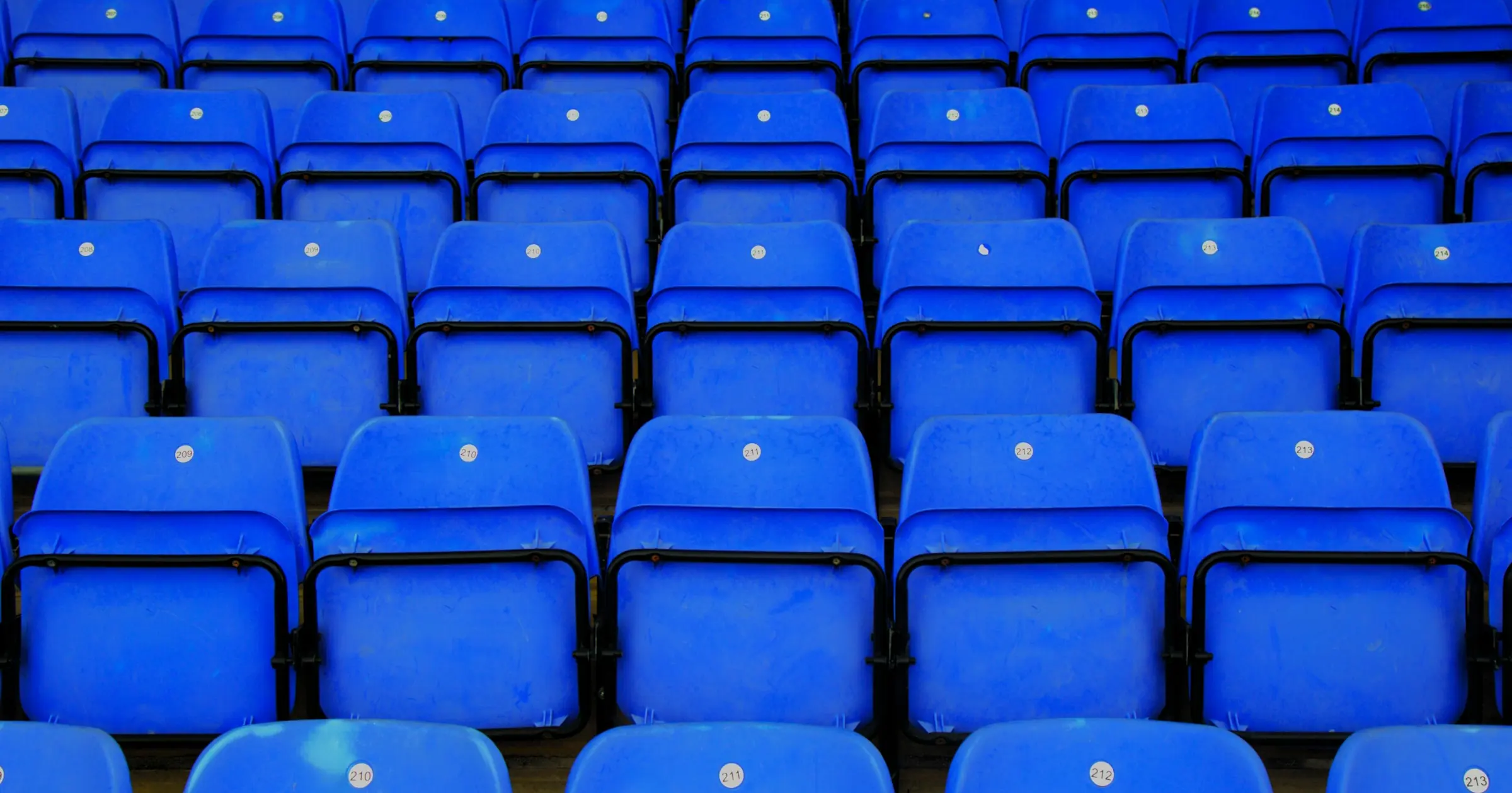 Rows of empty blue stadium seats
