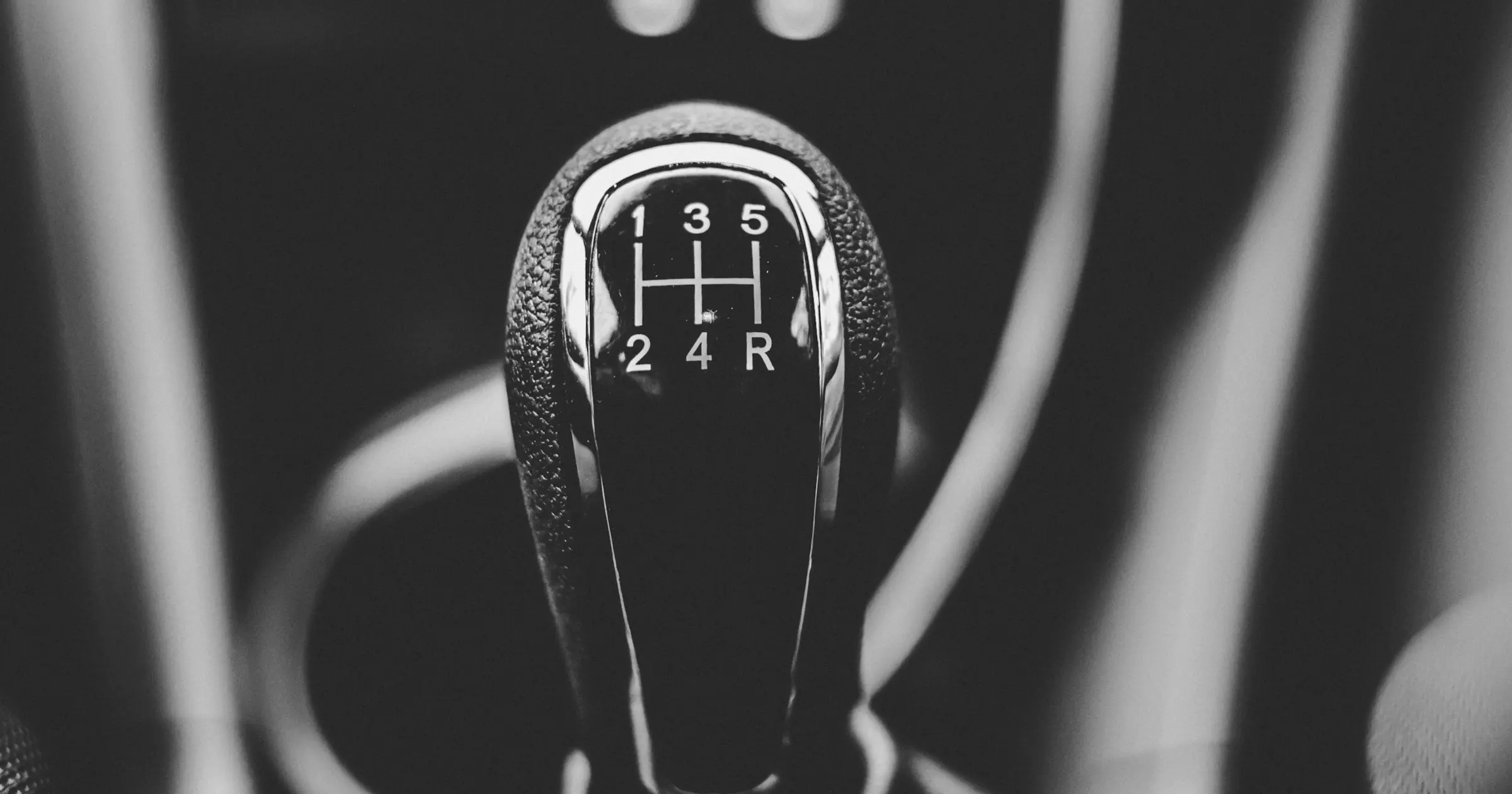 Black-and-white close-up of a manual gear-shift knob