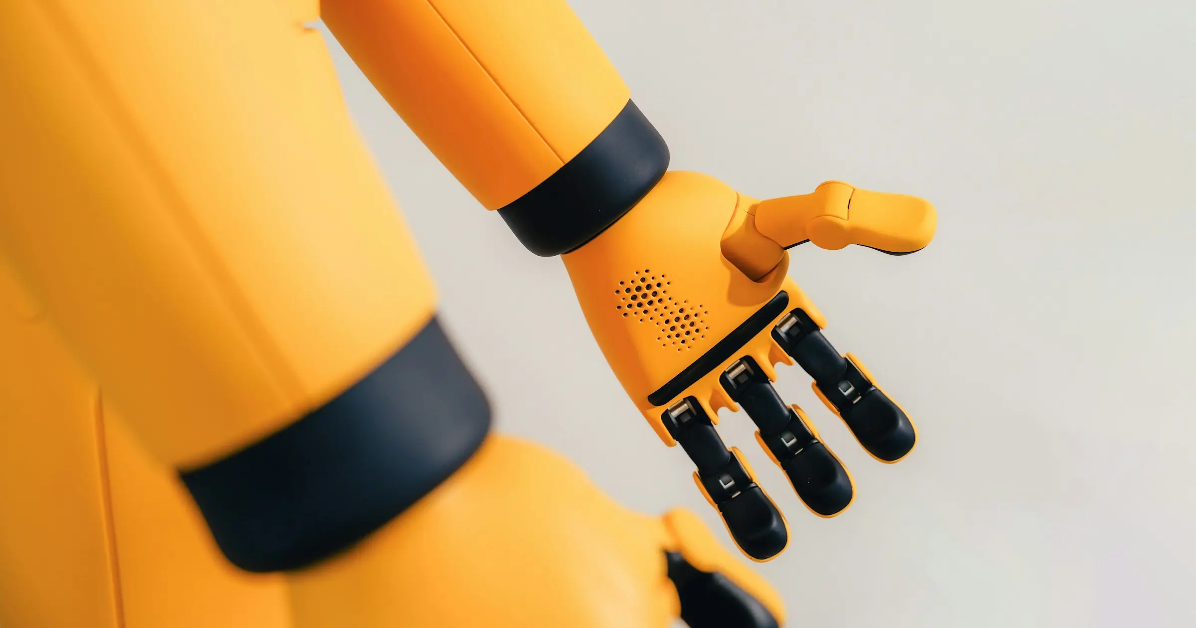 A yellow robot hand reaching out with its palm open