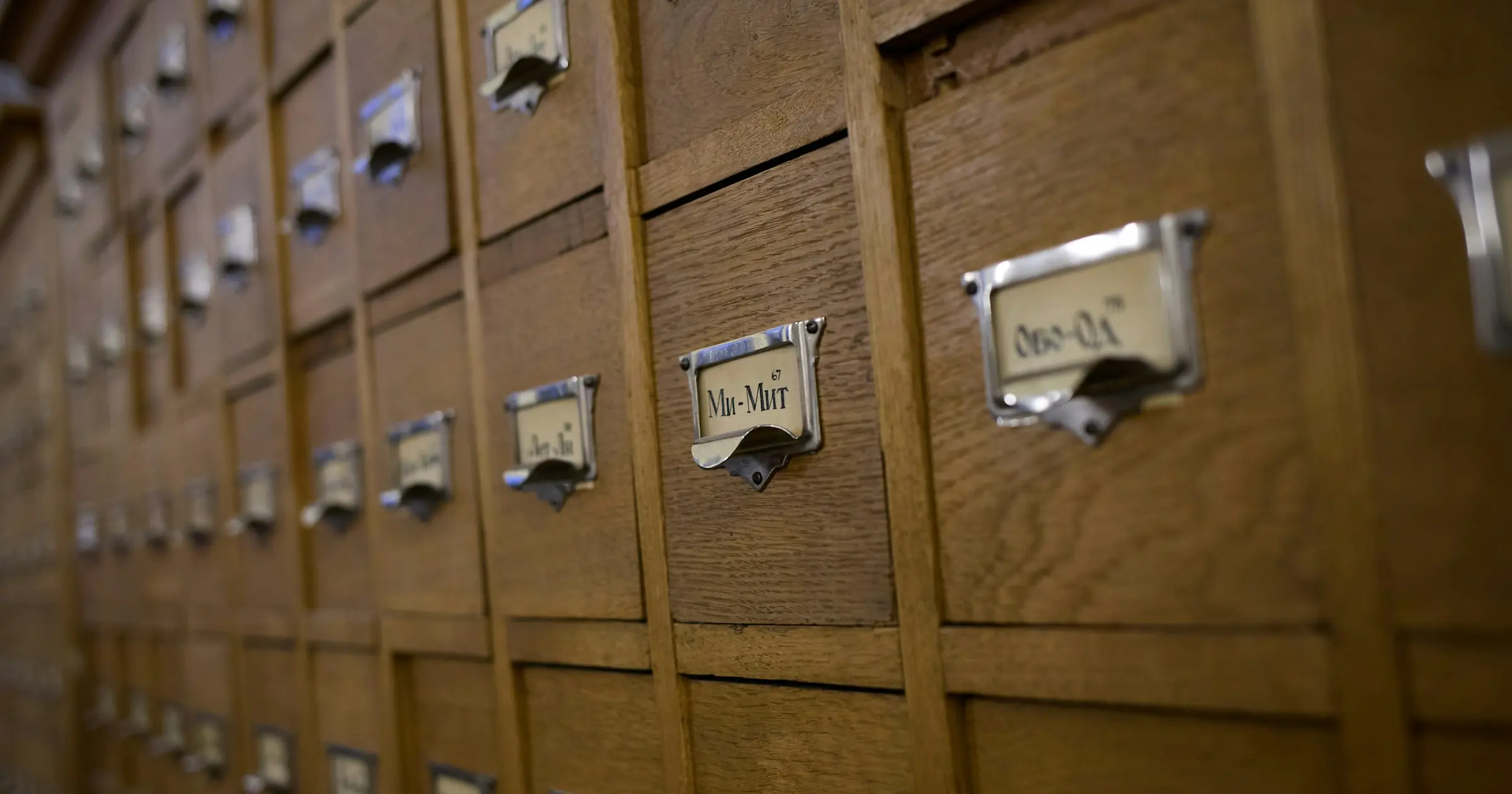 Rows of wooden card catalog drawers with metal label holders